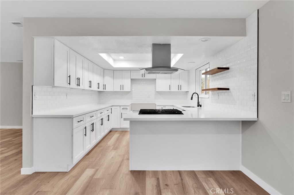 12532 Sholic Road Apple Valley, CA 92308 - Photo 15 of 41 a kitchen with stainless steel appliances granite countertop a sink stove and refrigerator