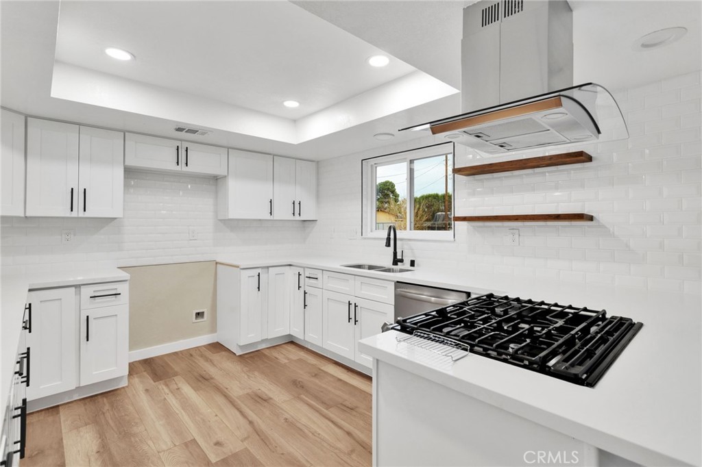 12532 Sholic Road Apple Valley, CA 92308 - Photo 16 of 41 a kitchen with white cabinets and appliances
