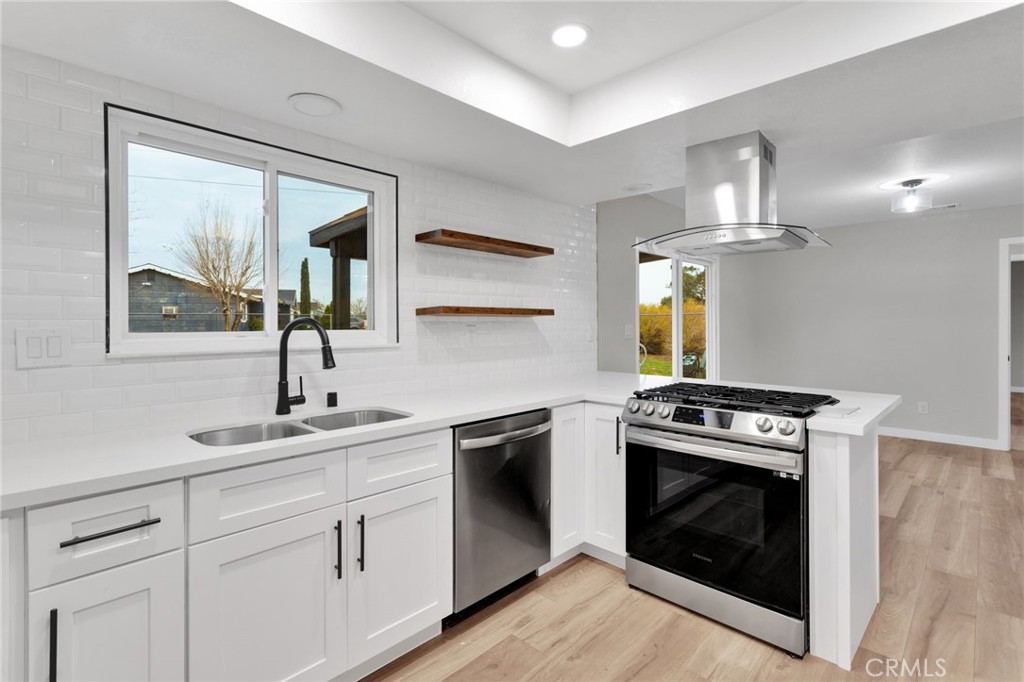 12532 Sholic Road Apple Valley, CA 92308 - Photo 17 of 41 a kitchen with cabinets a washer and dryer