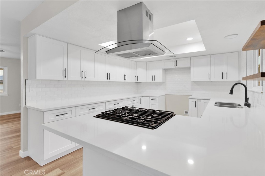 12532 Sholic Road Apple Valley, CA 92308 - Photo 19 of 41 a kitchen with cabinets a stove and a stove top oven