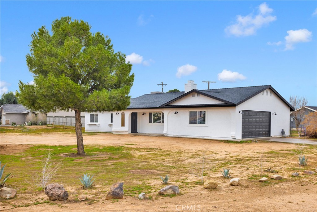 12532 Sholic Road Apple Valley, CA 92308 - Photo 2 of 41 a view of a house with a yard
