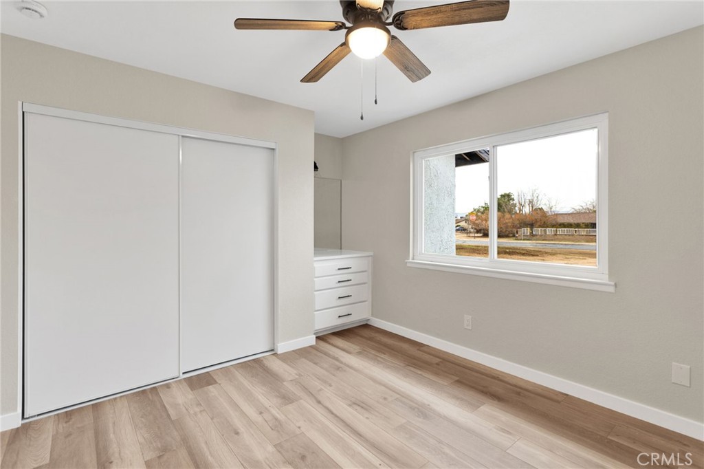 12532 Sholic Road Apple Valley, CA 92308 - Photo 21 of 41 a view of a bedroom with window and a ceiling fan