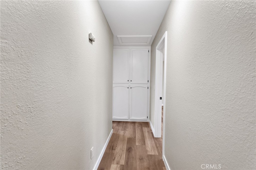 12532 Sholic Road Apple Valley, CA 92308 - Photo 24 of 41 a view of a hallway with wooden floor
