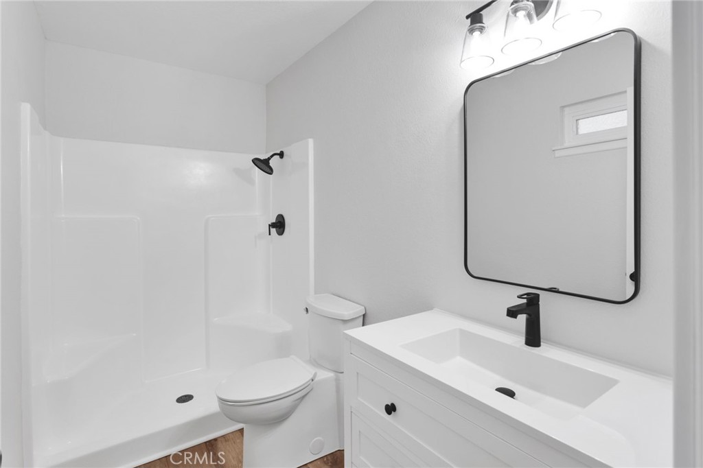 12532 Sholic Road Apple Valley, CA 92308 - Photo 28 of 41 a bathroom with a sink a toilet and shower