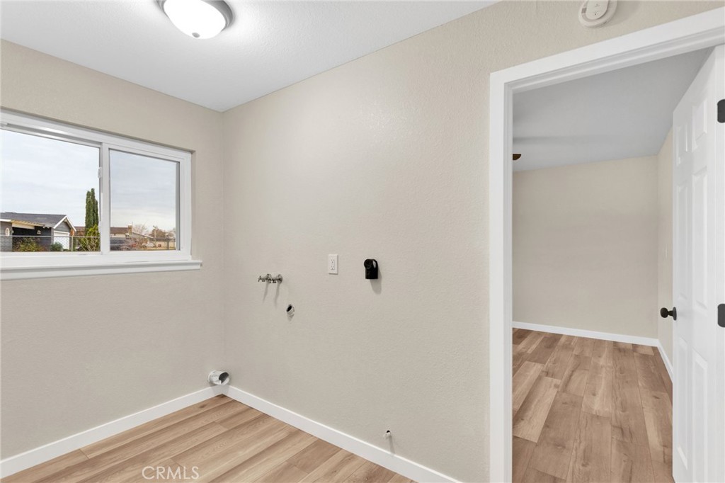 12532 Sholic Road Apple Valley, CA 92308 - Photo 32 of 41 a view of a small space with wooden floor and a window