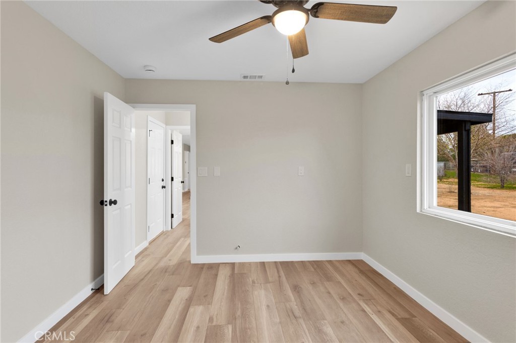 12532 Sholic Road Apple Valley, CA 92308 - Photo 34 of 41 wooden floor in an empty room with a window