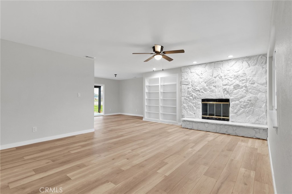 12532 Sholic Road Apple Valley, CA 92308 - Photo 10 of 41 a view of empty room with wooden floor and fan