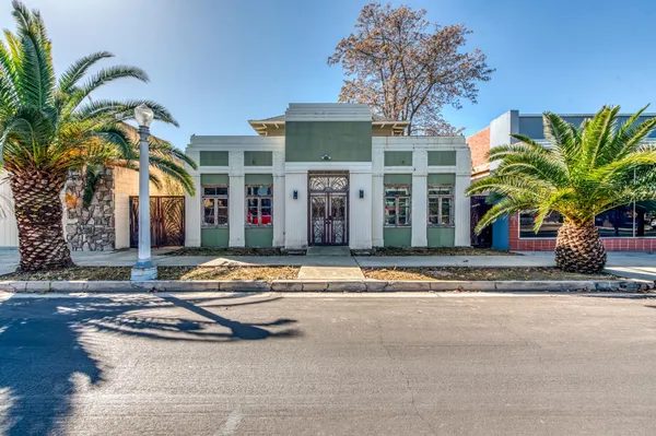 a house with palm tree in front of it
