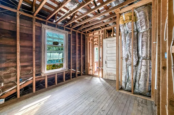 a living room with patio furniture and a rug