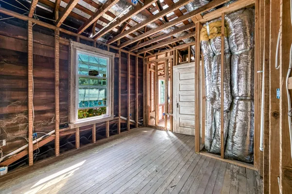 a house with green field in front of it