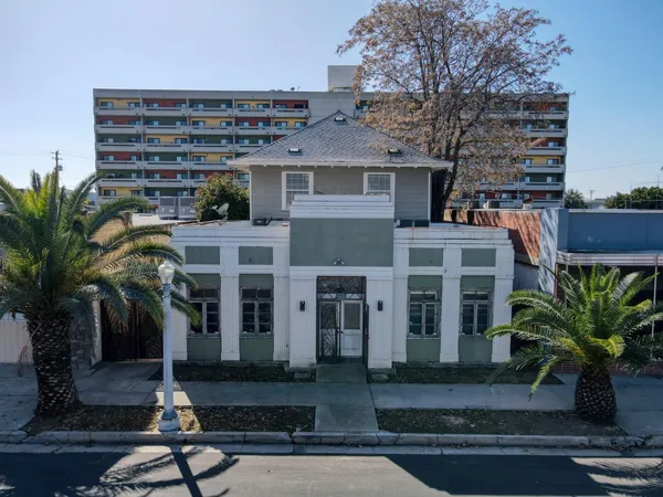 an aerial view of a house with a yard