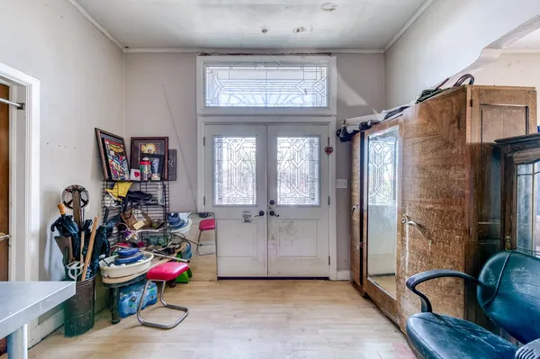 a living room with furniture kitchen view and large windows