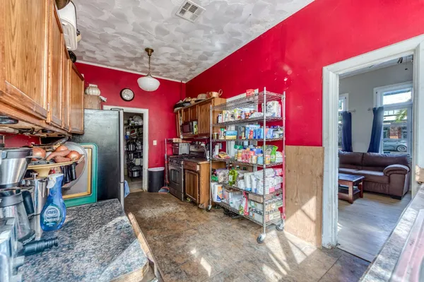 a kitchen with stainless steel appliances granite countertop a kitchen island a stove and white cabinets