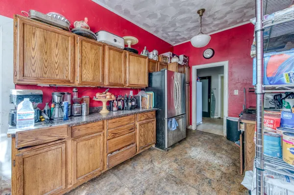 a view of patio with couple of chairs and a potted plant