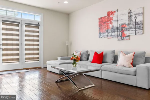 a living room with furniture and a kitchen view
