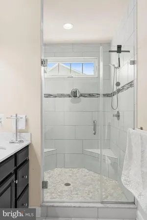 a bathroom with a sink a mirror and a shower