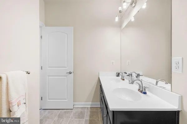 a bathroom with a sink double vanity and a mirror
