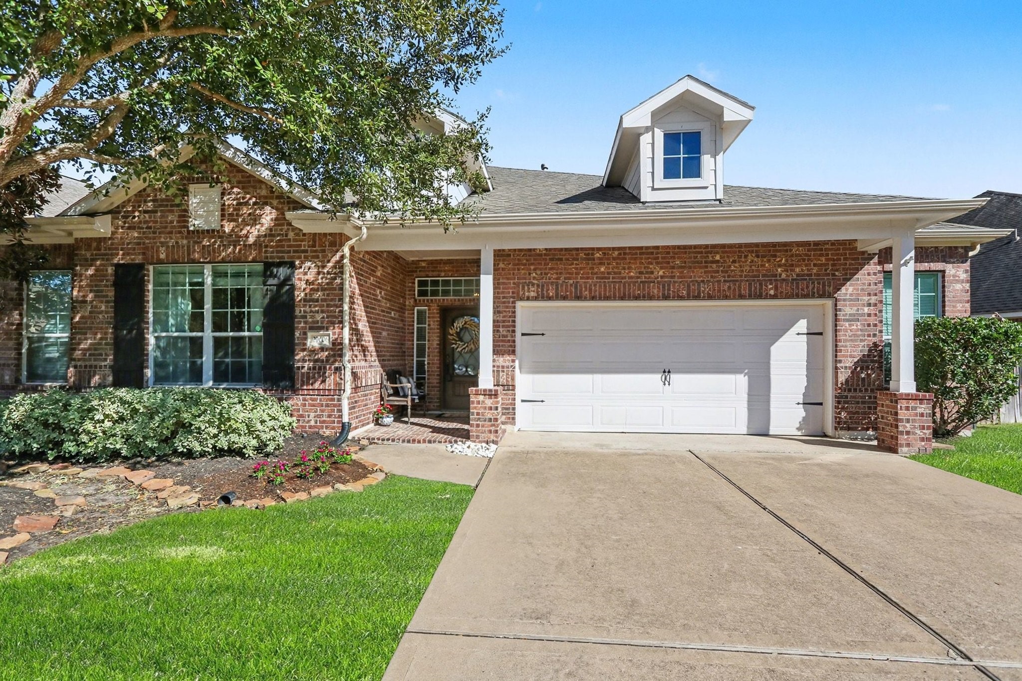 27006 Cliff Pointe Lane Katy, TX 77494 - Photo 1 of 34 Classic brick elevation with a welcoming covered entry, lush lawn, and timeless architectural details—beautifully maintained and move-in ready.