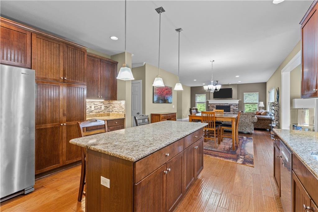 242 Kings Road Washington, PA 15301 - Photo 14 of 42 a kitchen with stainless steel appliances granite countertop table chairs sink refrigerator and microwave