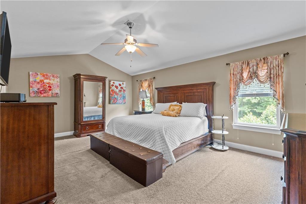242 Kings Road Washington, PA 15301 - Photo 20 of 42 a bedroom with a large bed and a chandelier