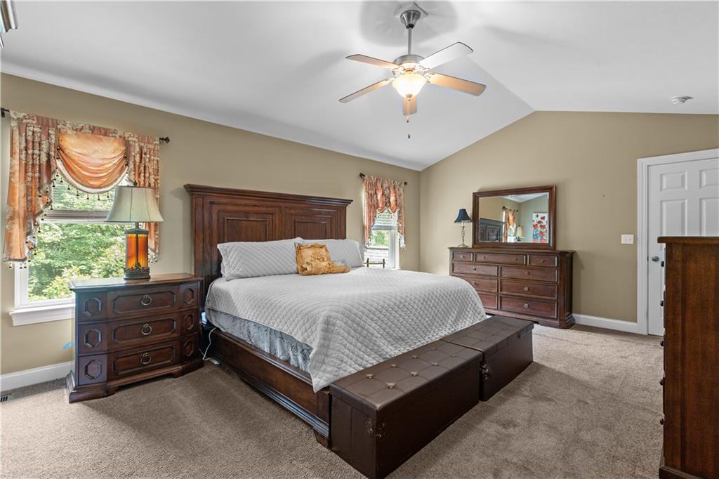 242 Kings Road Washington, PA 15301 - Photo 21 of 42 a spacious bedroom with a bed and a chandelier