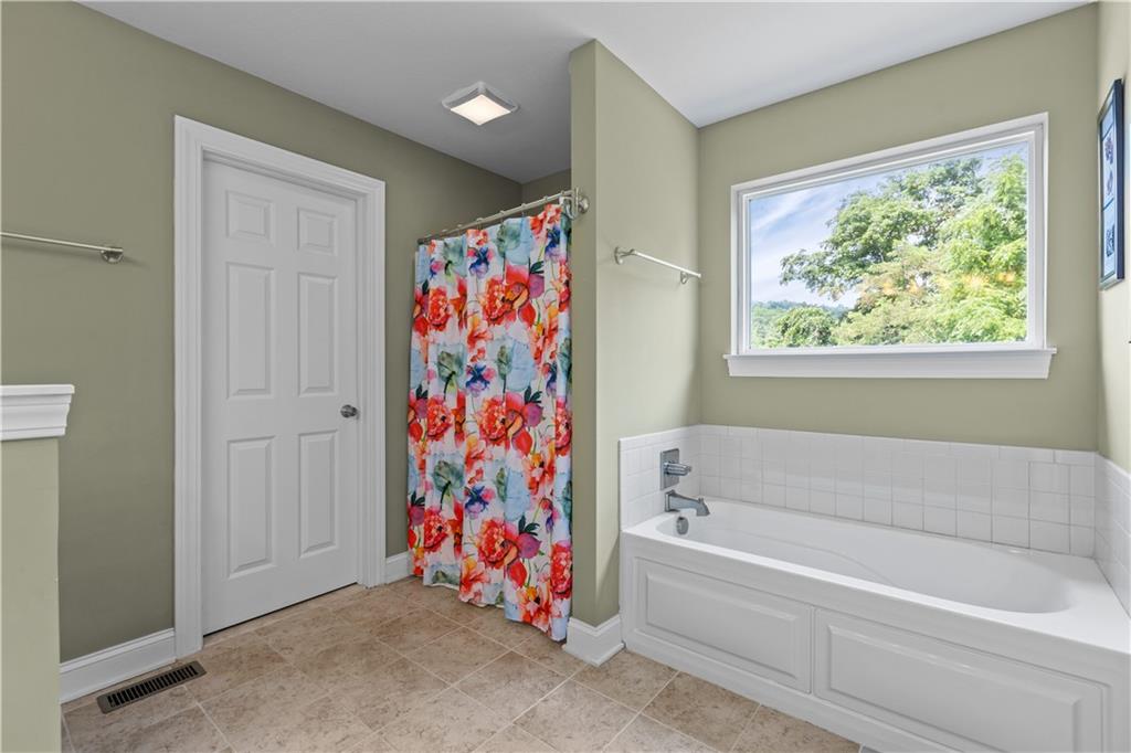242 Kings Road Washington, PA 15301 - Photo 24 of 42 a bathroom with a bathtub and a shower