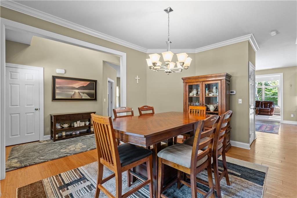 242 Kings Road Washington, PA 15301 - Photo 27 of 42 a dining room with furniture a chandelier and wooden floor