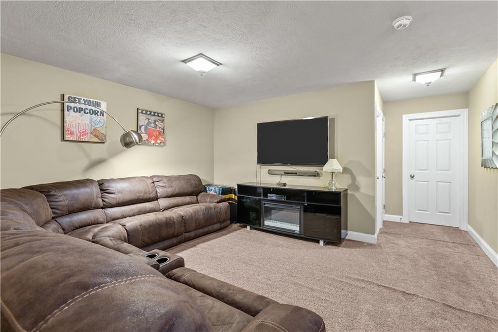 242 Kings Road Washington, PA 15301 - Photo 31 of 42 a living room with furniture and a flat screen tv