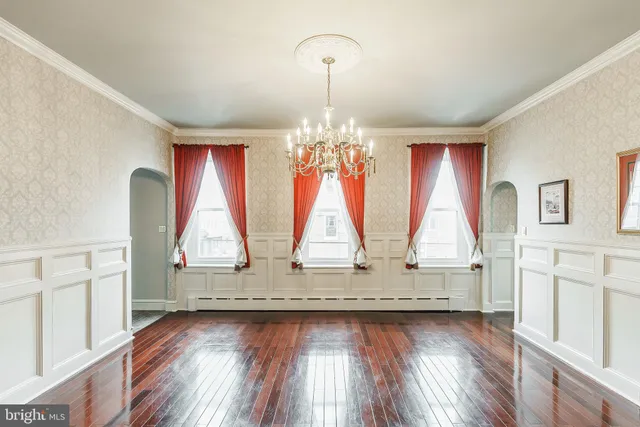 a view of room with wooden floor and windows