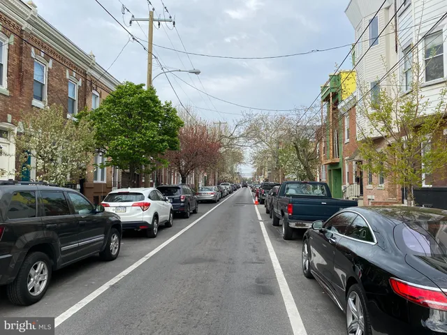a view of a city street with a car park side of the road