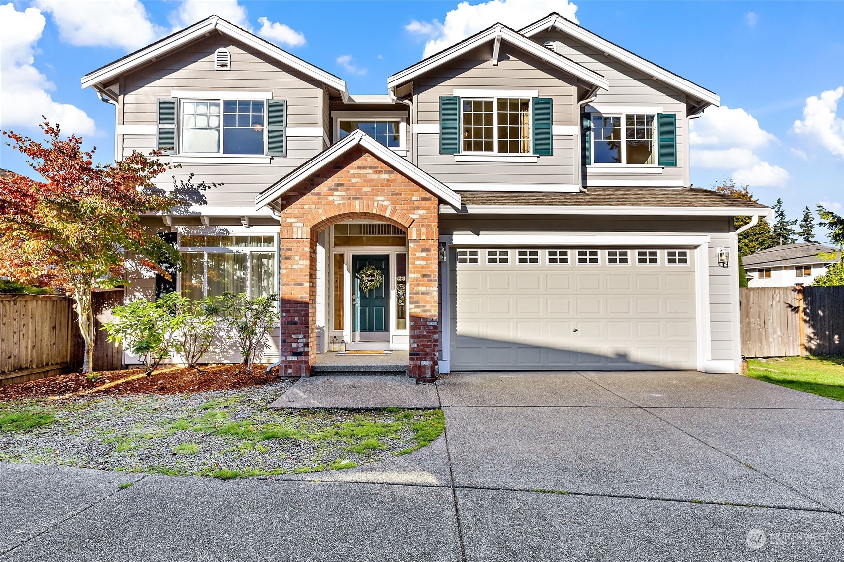 133 185th Place Southwest Bothell, WA 98012 - Photo 1 of 32 a front view of a house with a yard and garage