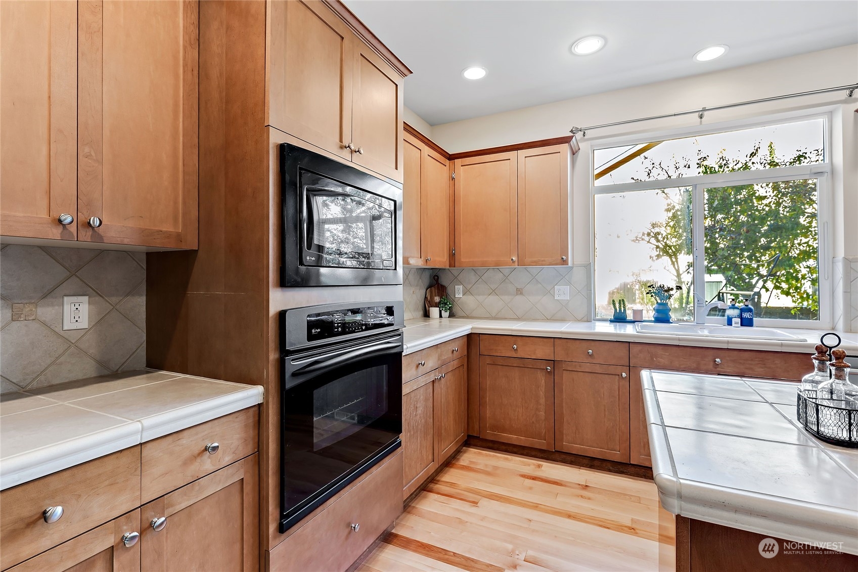 133 185th Place Southwest Bothell, WA 98012 - Photo 11 of 32 a kitchen with stainless steel appliances granite countertop a stove a sink and a microwave