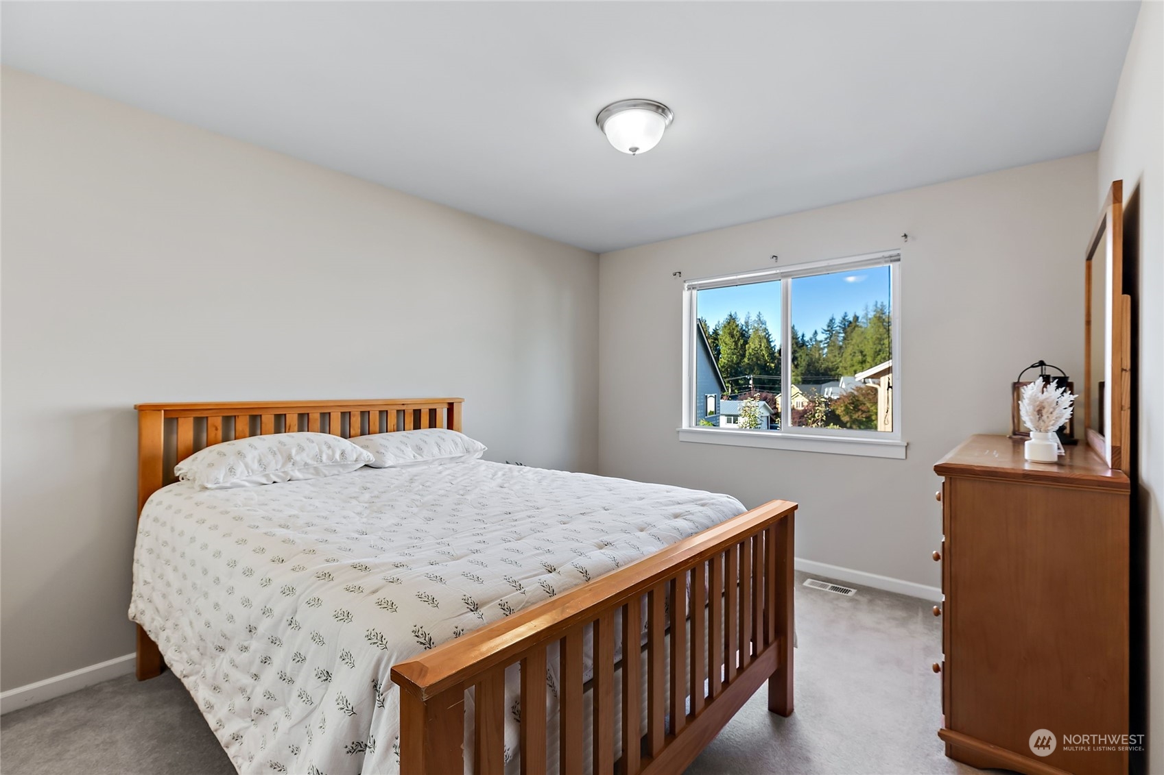133 185th Place Southwest Bothell, WA 98012 - Photo 25 of 32 a bedroom with a bed and a stove with wooden floor
