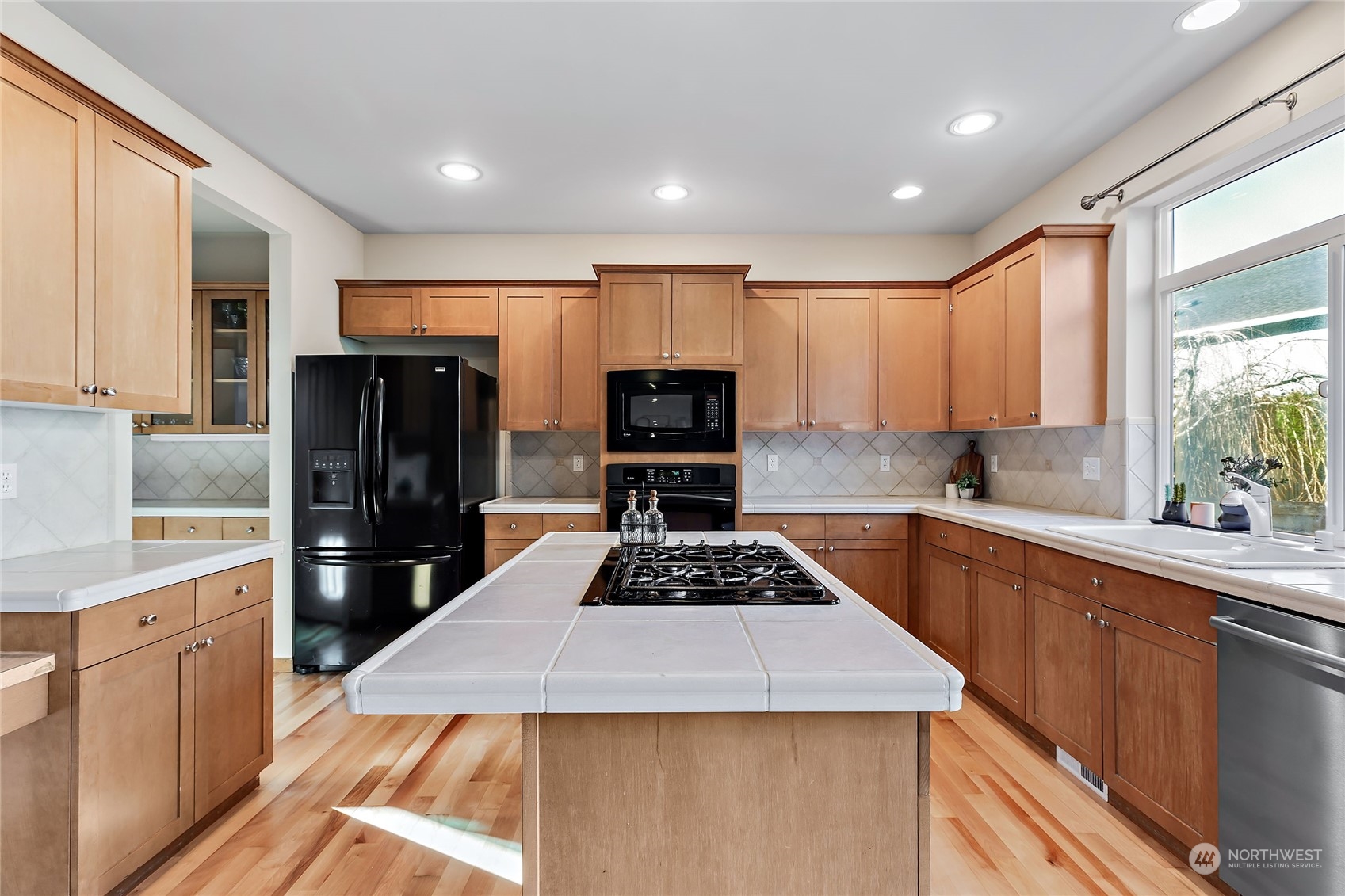 133 185th Place Southwest Bothell, WA 98012 - Photo 10 of 32 a kitchen with granite countertop stainless steel appliances a sink stove and refrigerator