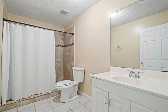 an empty room with a window and ceiling fan