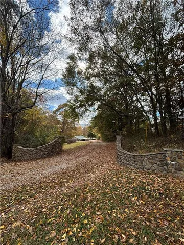 a view of a yard with large trees