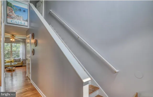 a view of entryway and hall with wooden floor