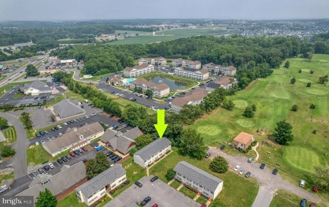 an aerial view of residential houses with outdoor space