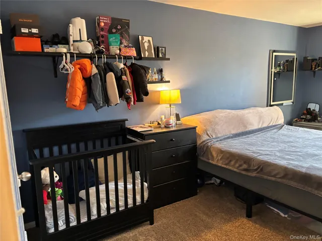 a bedroom with a bed and dresser