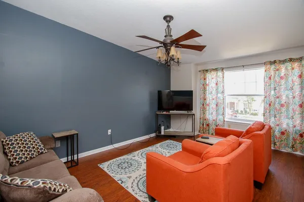 a living room with furniture and a flat screen tv
