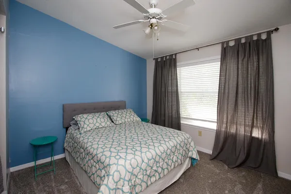 a bedroom with a bed and a window