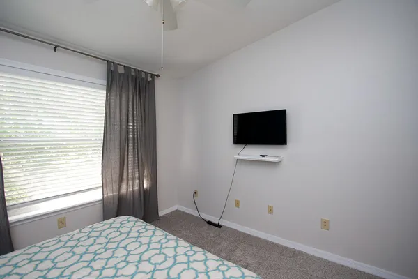 a large bed sitting in a bedroom next to a bathroom