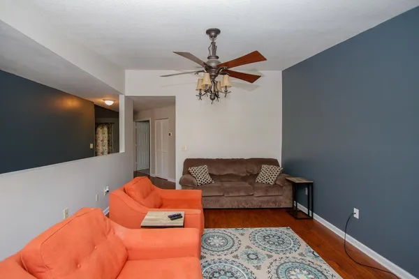 a living room with furniture and a chandelier