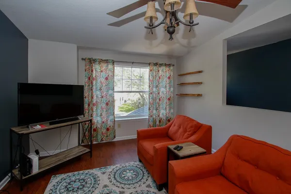 a living room with furniture and a flat screen tv