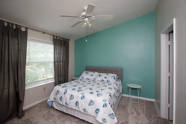 a bedroom with a bed and a window