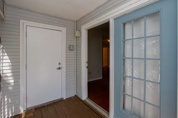 a view of a balcony with green trees