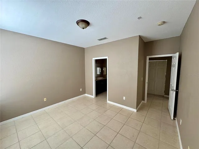 a spacious bathroom with a double vanity sink a mirror and a bathtub