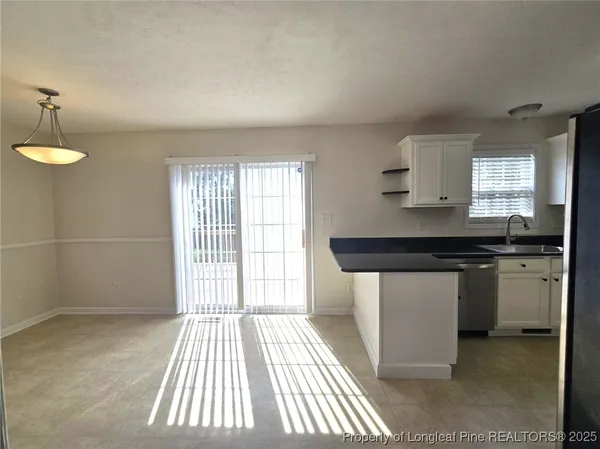 a kitchen with a sink and a refrigerator