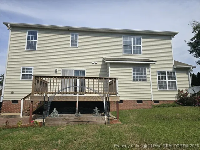 a view of a house with a backyard