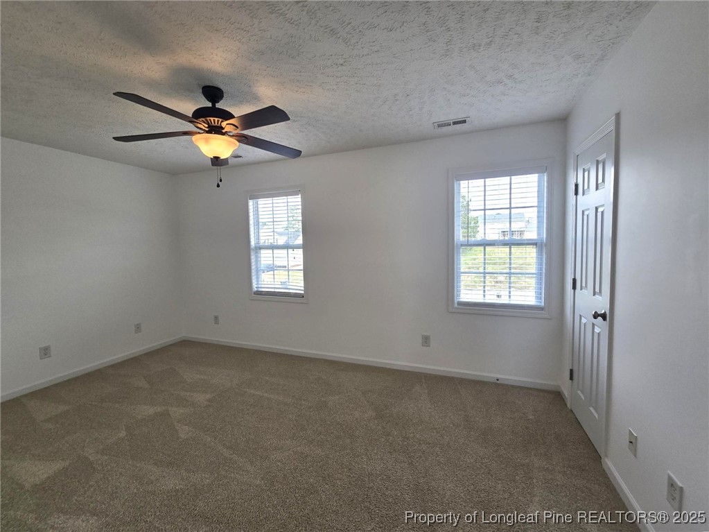 115 Haywood Street Spring Lake, NC 28390 - Photo 32 of 35 an empty room with windows and chandelier fan